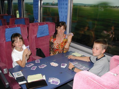 Lisa, Justine and Eric playing cards on a train